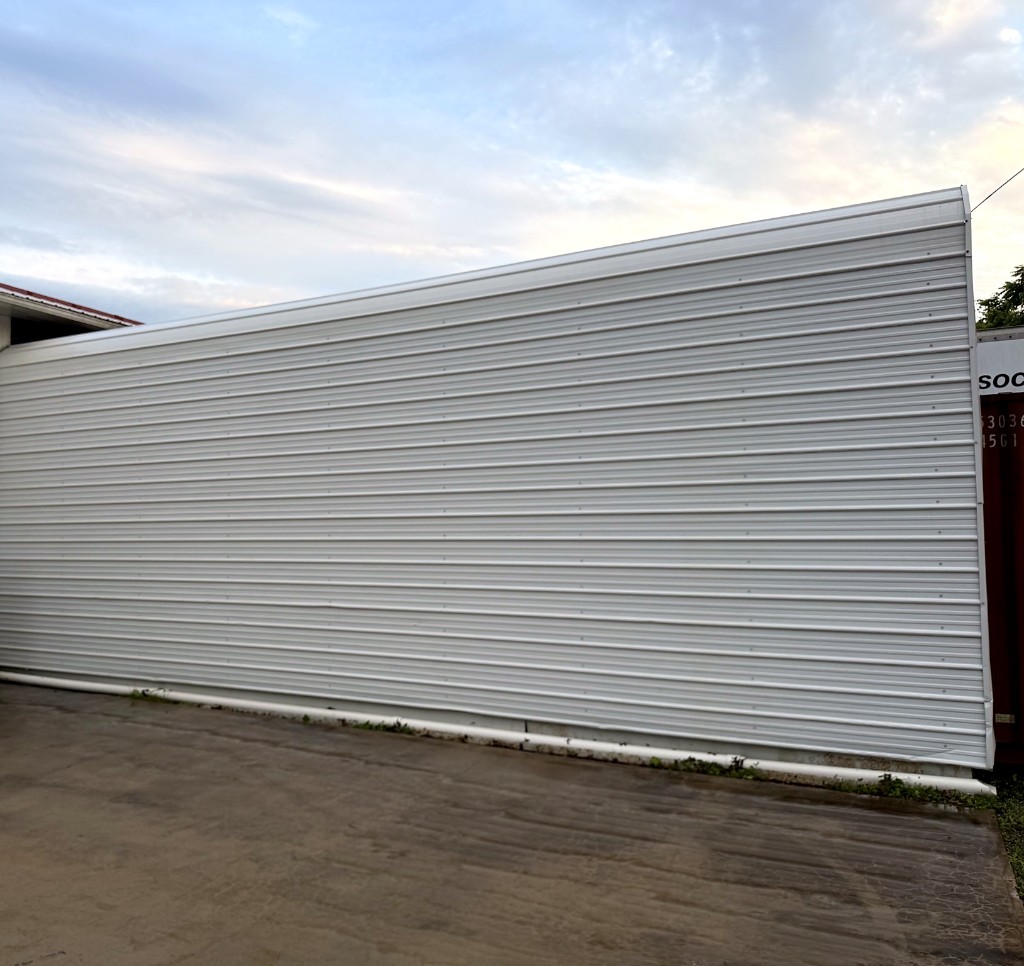 Commercial metal wall after pressure washing — clean white corrugated siding